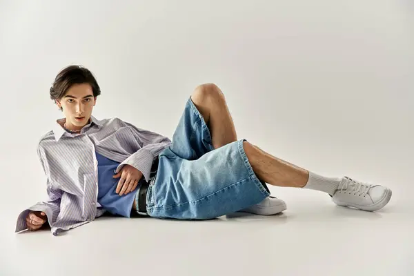 Young non binary individual displays unique fashion and confident posture in trendy attire. — Stock Photo