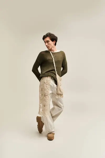 A young non binary person displays a trendy outfit in a stylish indoor space, celebrating identity. — Stock Photo