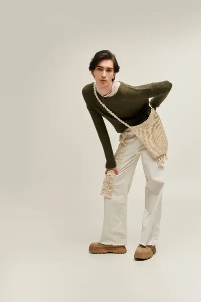 Young non binary individual sports a stylish outfit with unique textures, showcasing identity. — Stock Photo