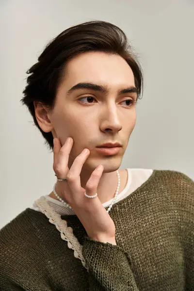 A stylish young person confidently explores their identity in a minimalist setting. — Stock Photo