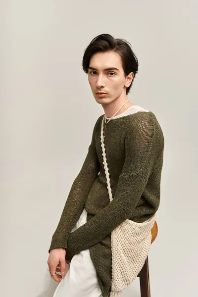 A stylish non binary individual poses confidently in a chic outfit, embodying modern fashion trends. — Stock Photo