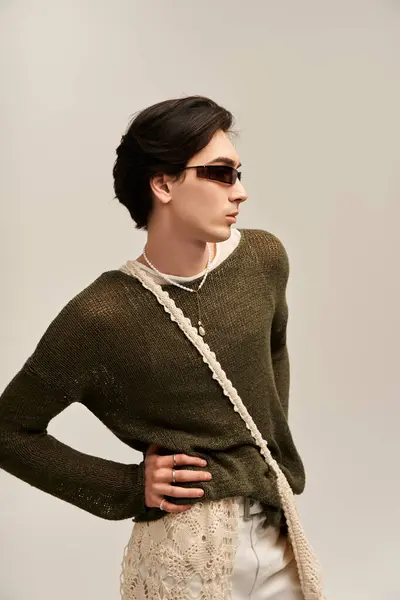 A confident young person showcases their unique fashion sense in a chic environment. — Stock Photo