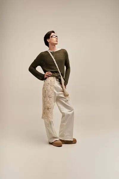 A stylish young non binary person poses confidently, expressing their unique fashion sense. — Stock Photo