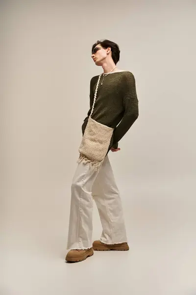 A confident non-binary person poses stylishly against a chic studio backdrop. — Stock Photo