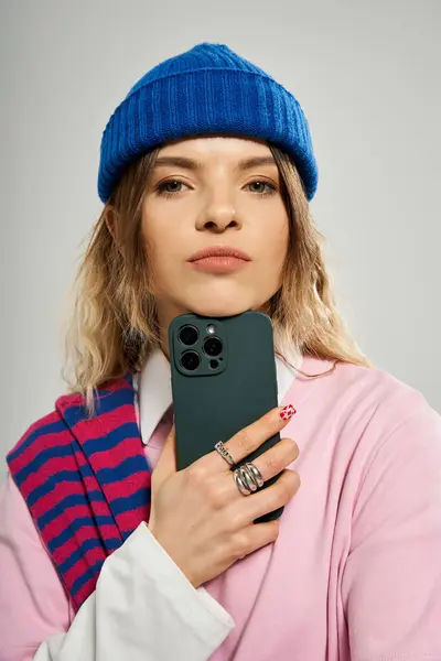 A pretty young woman showcases her trendy outfit and colorful accessories in a vibrant studio. — Stock Photo