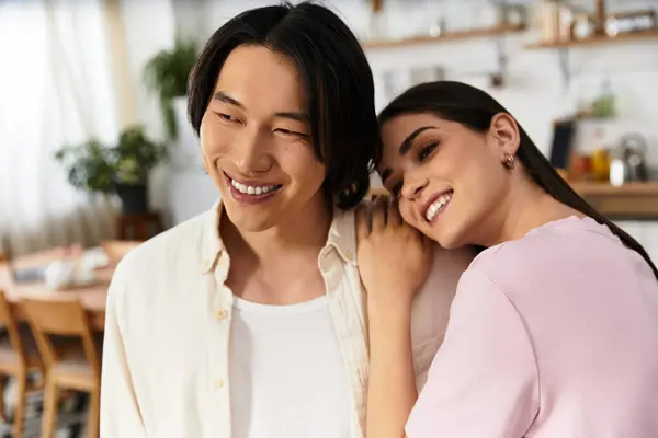 Couple shares a joyful moment at home, embracing warmth and love in their everyday life. — Stock Photo