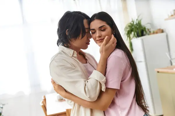 A loving couple enjoys tender moments at home, sharing smiles and affection in their kitchen. — Stock Photo