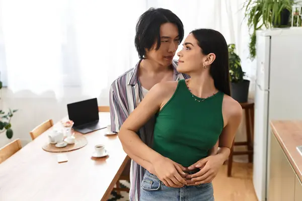 A man and woman embrace lovingly in a warm home environment filled with personal touches. — Stock Photo