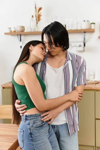 A loving couple embraces softly in their inviting kitchen, sharing a heartfelt connection. — Stock Photo