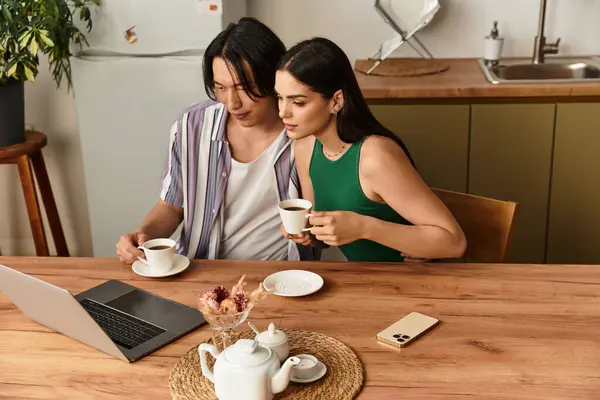 A loving couple enjoys each others company while sipping coffee at their kitchen table. — Stock Photo
