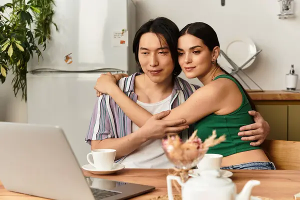 Loving couple wrapped in each others arms, smiling during a joyful video call at home — Stock Photo