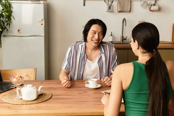Living room filled with warmth as a couple shares laughter and love during coffee time at home. — Stock Photo