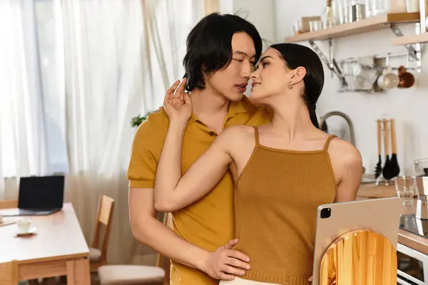 A couple embraces intimately, sharing a tender moment in their inviting kitchen space. — Stock Photo