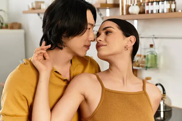 A couple embraces closely while sharing a loving glance in their warm, inviting kitchen. — Stock Photo