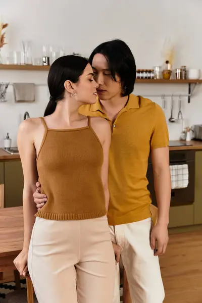 Couple enjoys a sweet embrace at home, surrounded by a warm and inviting atmosphere. — Stock Photo