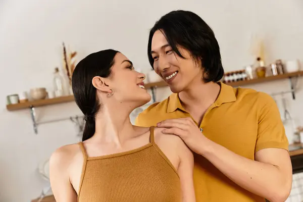 Couple gazes into each others eyes, radiating affection and happiness in a warm living space. — Stock Photo