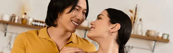 Loving couple gazes into each others eyes with joy and warmth in their cozy living space. — Stock Photo
