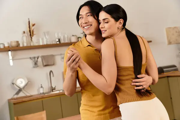 A loving couple embraces in their beautiful home, radiating warmth and affection for each other. — Stock Photo