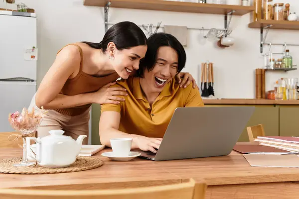 A couple shares quality time, smiling and working together in their cozy kitchen. — Stock Photo