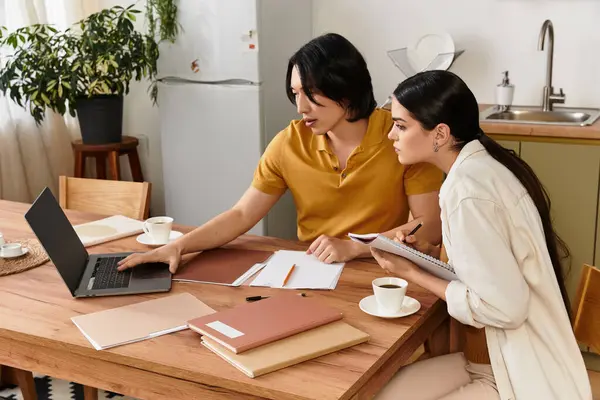 Loving couple collaborates at their cozy dining table, sharing thoughts and notes for future plans. — Stock Photo