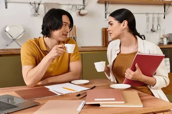 Loving couple engages in deep conversation and laughter over warm drinks in their kitchen. — Stock Photo