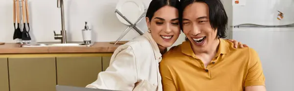 Couple enjoys a fun and loving moment together, sharing laughter in their warm kitchen. — Stock Photo