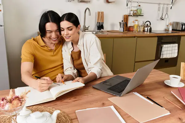 A couple shares ideas and collaborates on a project while enjoying time in their kitchen. — Stock Photo