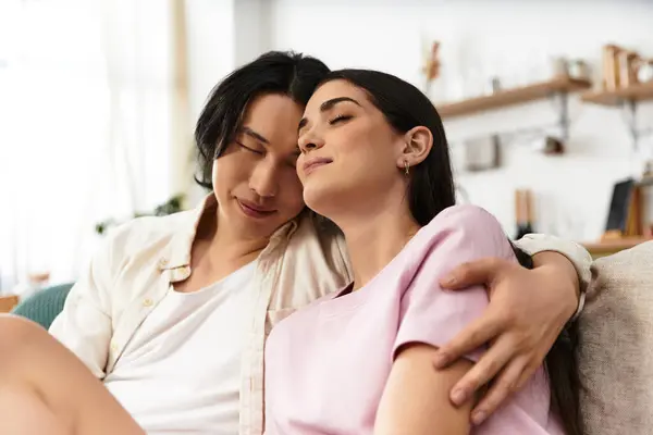 A tender moment unfolds as a couple relaxes together at home, sharing warmth and affection. — Stock Photo