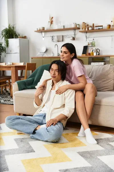 A couple enjoys each others company in their cozy living room, radiating warmth and love. — Stock Photo