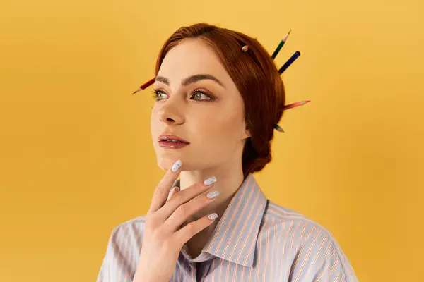A beautiful woman poses thoughtfully, showcasing her artistic flair with pencils in her hair. — Stock Photo