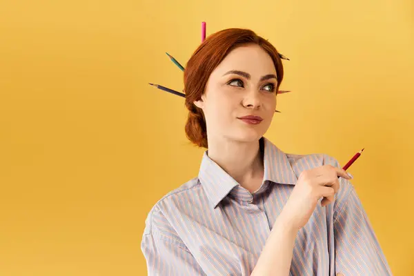Young woman expresses her artistic flair with colorful pencils playfully arranged in her hair. — Stock Photo