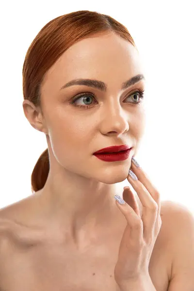 A young woman with red hair and bold red lips gazes thoughtfully, showcasing her elegant allure. — Stock Photo