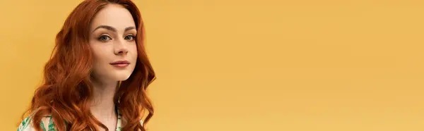 A beautiful woman with striking red hair showcases her charm and confidence in a bright setting. — Stock Photo