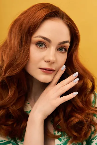 A young woman with striking red hair poses gracefully, showing off her polished nails and smile. — Stock Photo