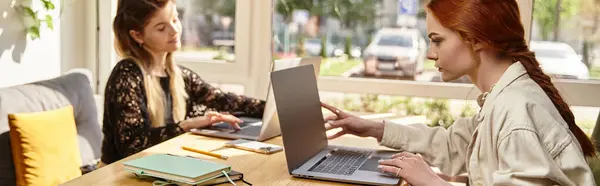 Two young women enjoy their time working remotely together in a stylish cafe setting, banner — Stock Photo
