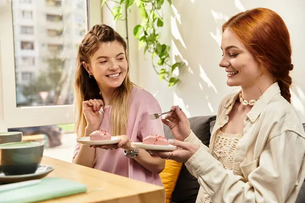 Two young women delight in a lovely dessert experience, showcasing their friendship and joy. — Stock Photo