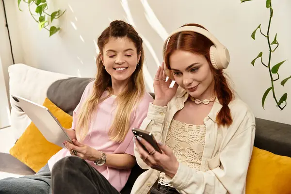 Two young women share laughs and moments in a trendy cafe setting. — Stock Photo