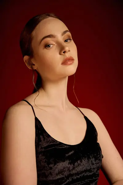 A beautiful young woman showcases elegance in a little black dress while exuding confidence. — Stock Photo