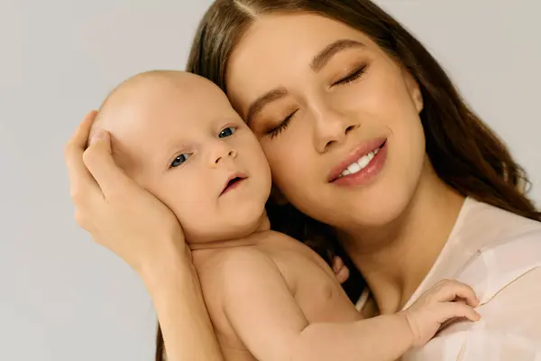 Delicate interaction between a loving mother and her infant, showcasing warmth and joy together. — Stock Photo