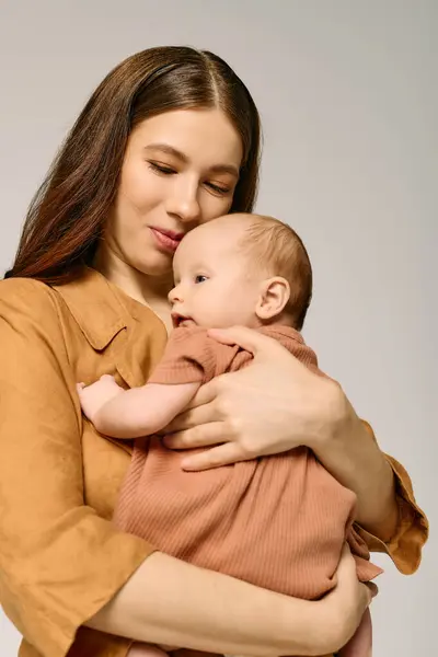 A loving mother holds her baby close, radiating warmth and joy in their connection. — Stock Photo