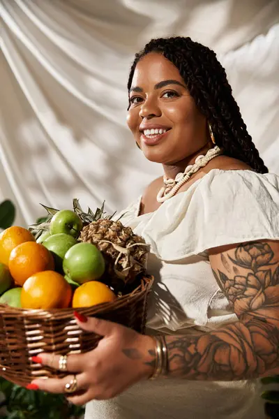 A pretty African American woman with braids smiles brightly while surrounded by green plants. — Stock Photo