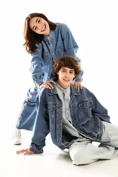 Stylish young couple showcases their love in casual denim attire, sharing a joyful moment together. — Stock Photo