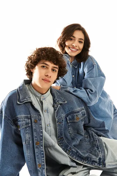 A trendy young couple radiates love and happiness while posing in matching denim outfits. — Stock Photo