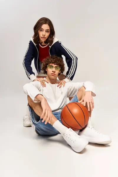 Young couple poses playfully in a fashion forward studio, exuding love and style together. — Stock Photo