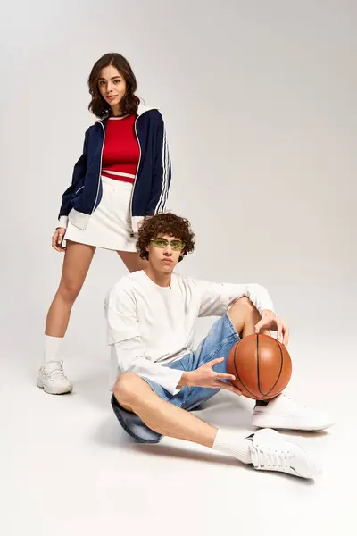 Young couple exuding love and style, playfully showcasing their sporty fashion while posing. — Stock Photo