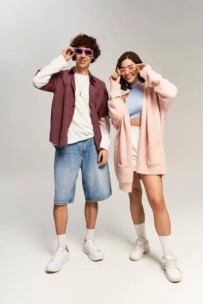 A young couple enjoys a joyful moment in their stylish summer outfits. — Stock Photo
