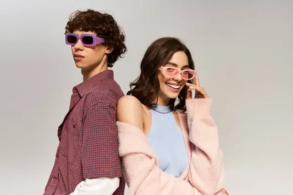 A young couple stands together showcasing their fashion sense, exuding joy and love. — Stock Photo