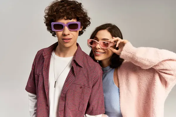 Two fashionable young individuals express their love and joy while wearing vibrant sunglasses. — Stock Photo