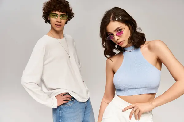 Stylish couple expresses their love and connection through fashionable attire in a studio. — Stock Photo