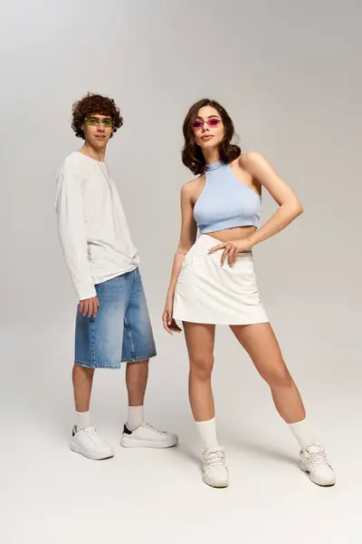 Stylish couple poses confidently, showcasing their love and vibrant fashion choices in studio. — Stock Photo